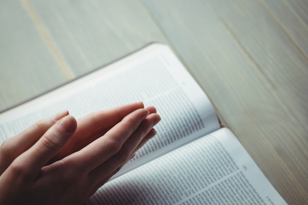 Woman praying with her bible