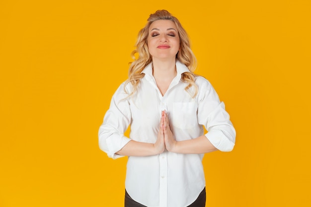 A woman prays, begs, and begs for her eyes tightly closed and a clutching hand praying to God