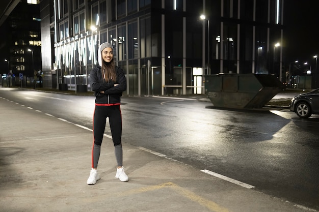 A woman prepares for a night run around the city