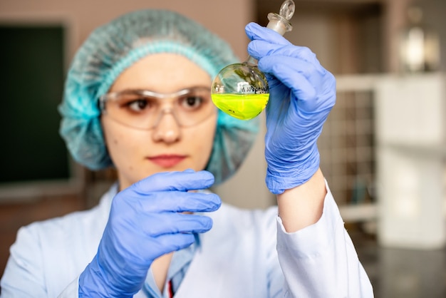 The woman prepares a solution for a lesson in chemistry or biotechnology