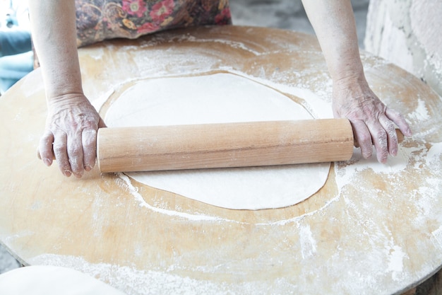 Woman preparing armenian bread lavash.