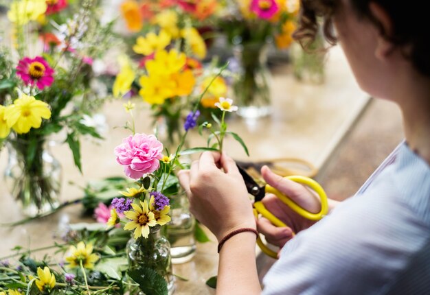 Woman preparing and arranging flowers