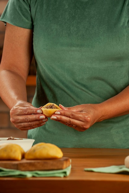 Woman preparing brazilian snacks beef stufing croquette risolis de carne