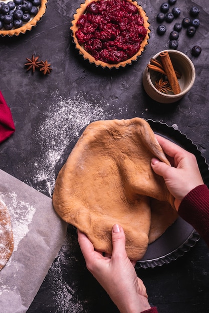 Woman preparing a christmas pie with cherry