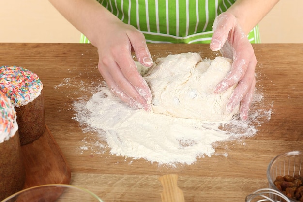 Woman preparing Easter cake in kitchen