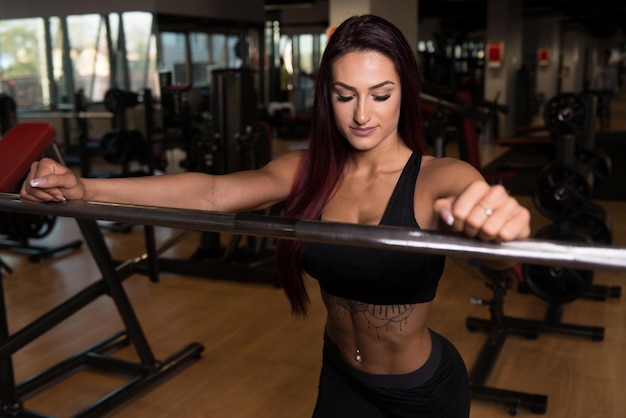 Woman Preparing To Exercise Squat Barbell