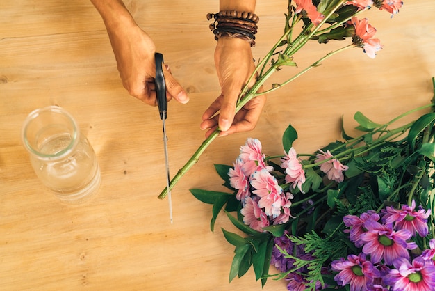 Woman preparing flower daisy bouquet, florist.