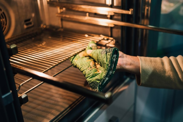 Woman preparing oven for baking