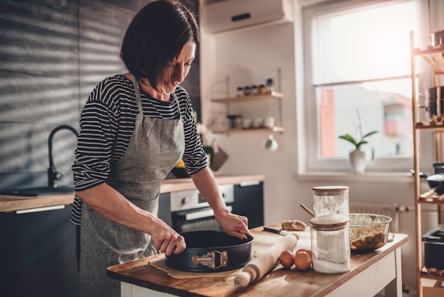 Woman preparing pie crust dough