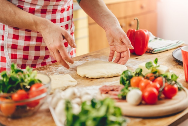 Woman preparing pizza