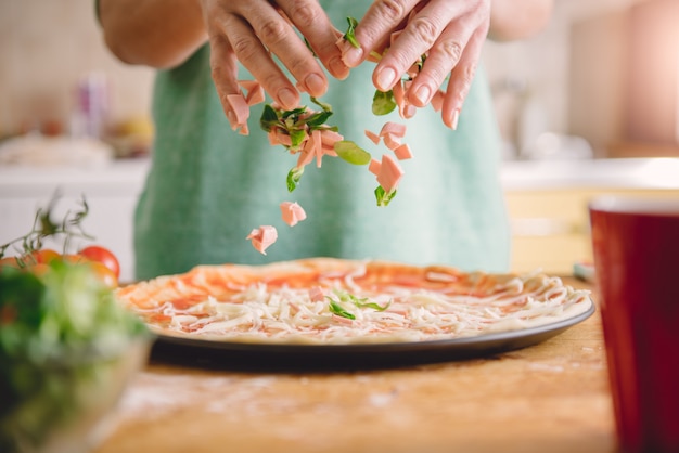 Woman preparing pizza