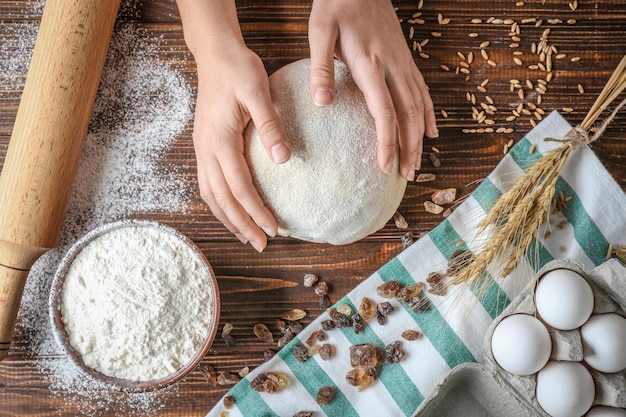 Woman preparing puff pastry on table