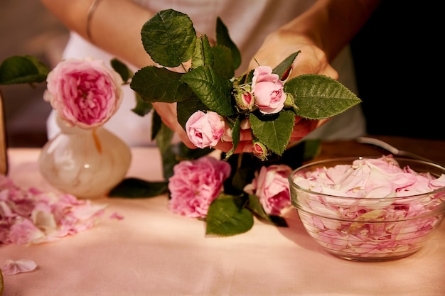 Donna che prepara fiori di rose di tè marmellata di rose di tè naturale fatta in casa estetica che prepara con zucchero, limone e petali di rosa di tè ricetta sana fotografia di stile di vita