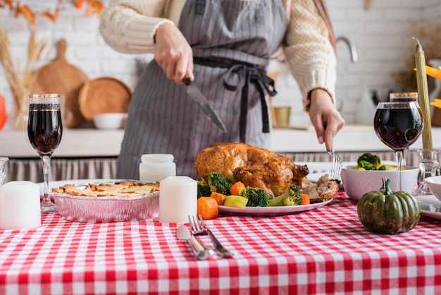 Woman preparing thanksgiving dinner at home kitchen decorating