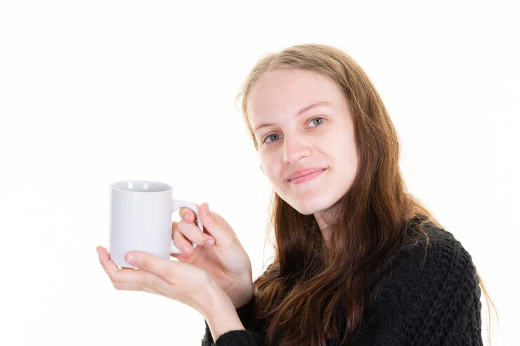 Woman presenting unbranded empty white hot drink mug