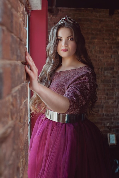 woman princess (queen) in long purple queen's dress and crown  