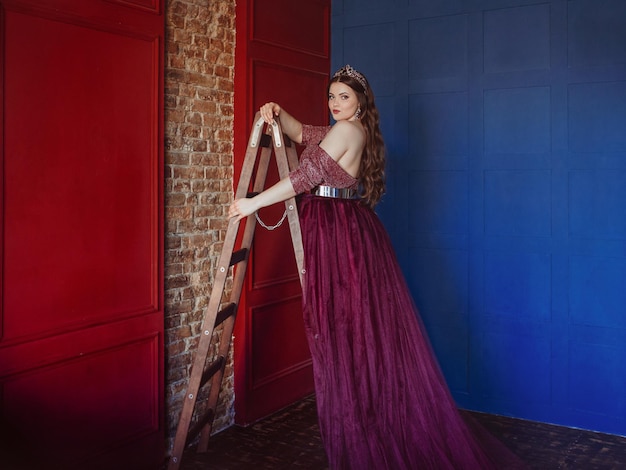 woman princess (queen) in long purple queen's dress and crown