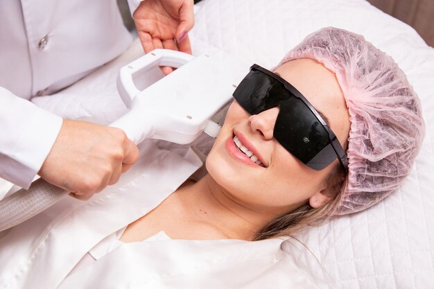 Woman in professional beauty salon during photoepilation procedure