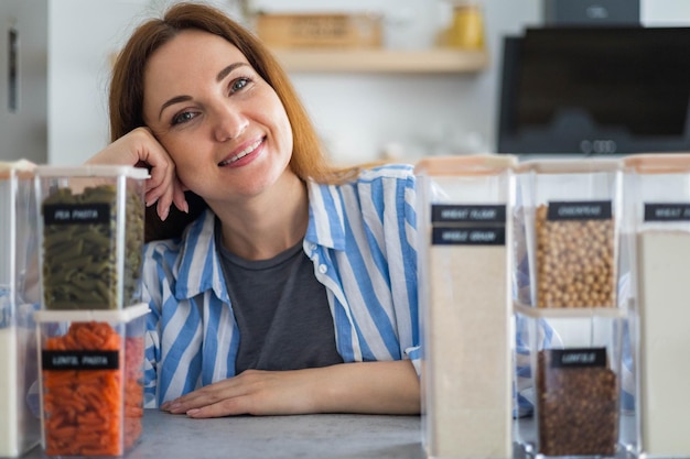 Woman professional space organizer smiling posing with case\
boxes for comfortable product storage