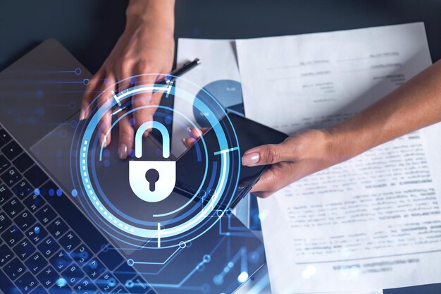 A woman programmer is typing a code on computer to protect a cyber security from hacker attacks and save clients confidential data Padlock Hologram icons over the typing hands Casual wear