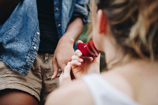 Woman proposing to her happy girlfriend outdoors love and marriage concept