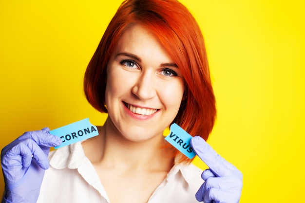 Woman in protective gloves holding inscription