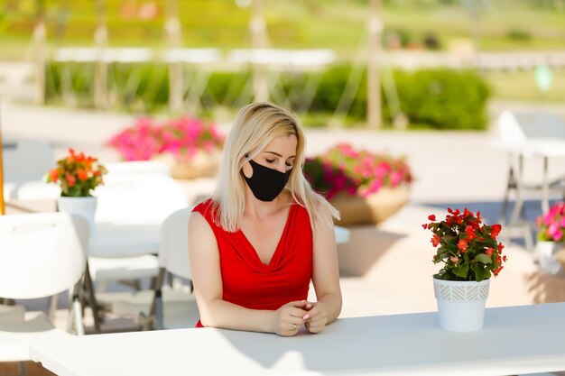 woman in protective mask on the summer terrace