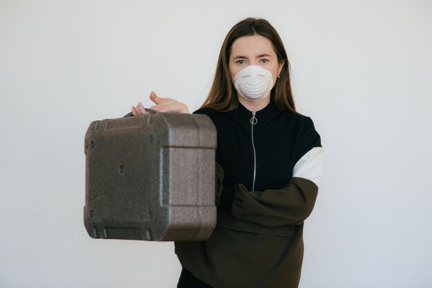 Woman in protective mask with grey case