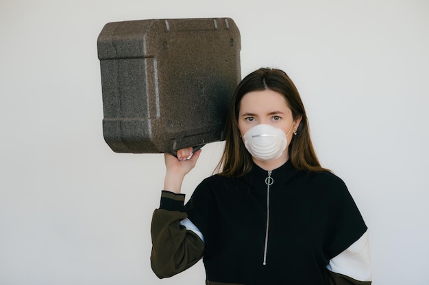 Woman in protective mask with grey case