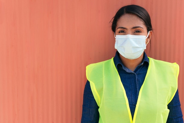 Woman in a protective mask working in the industry.