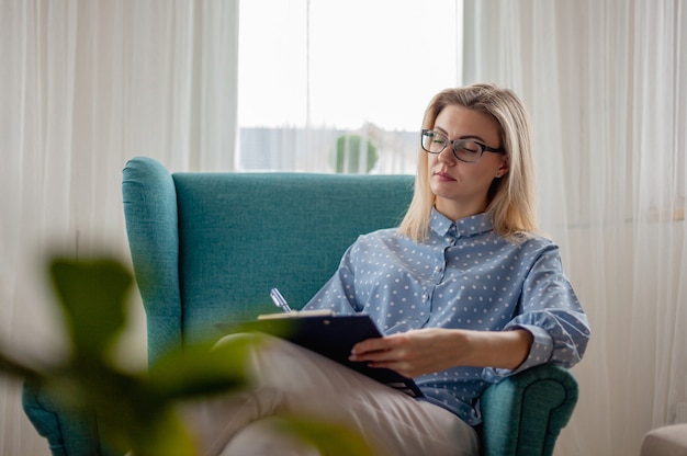 Photo woman psychologist or psychotherapist with eyeglasses sitting in