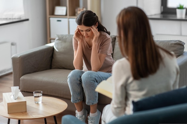 woman and psychologist at psychotherapy session