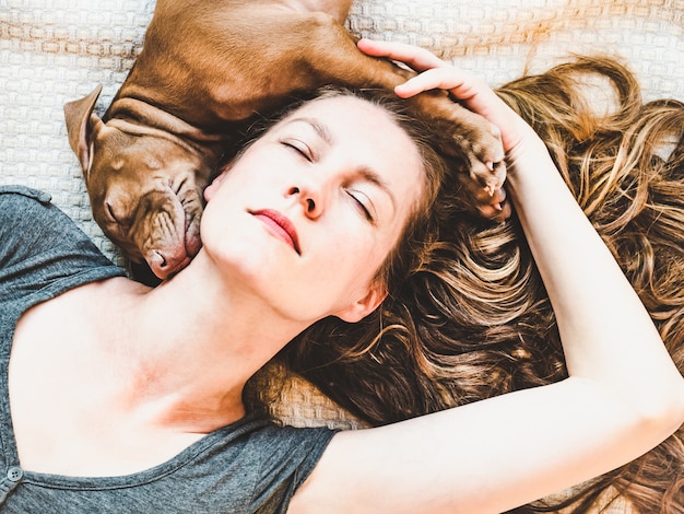 Woman and puppy resting on a plaid