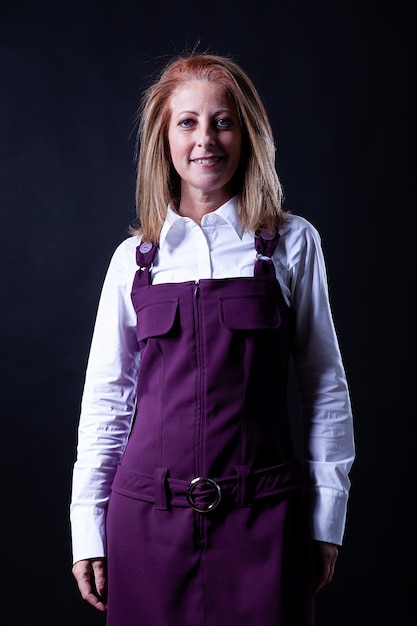 Woman in purple dress photoshoot on black background. Casual mood,.