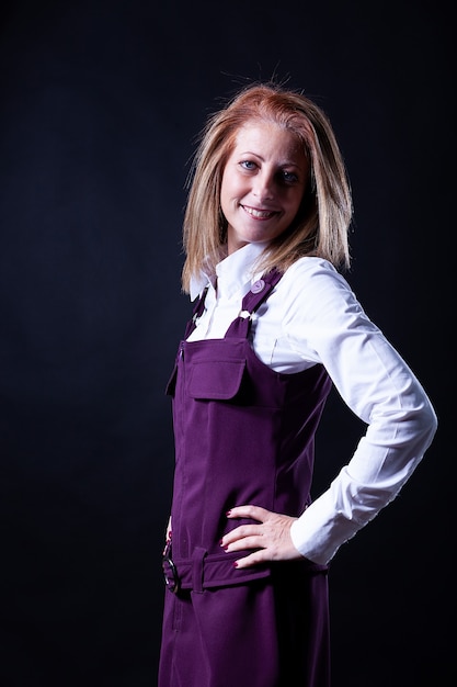 Woman in purple dress photoshoot on black background. Casual mood,.