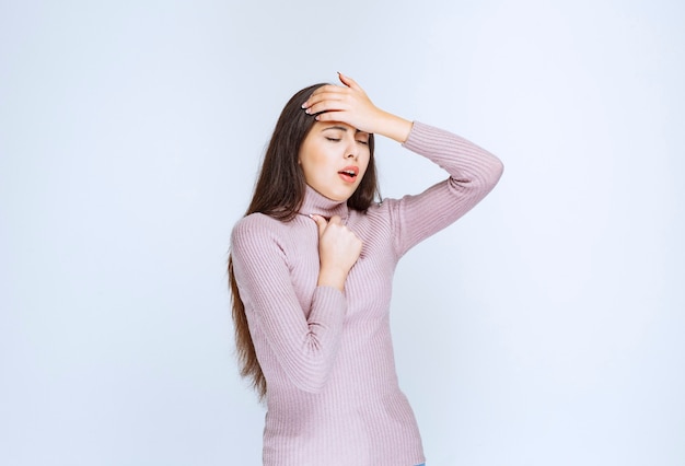 woman in purple shirt has sore throat.