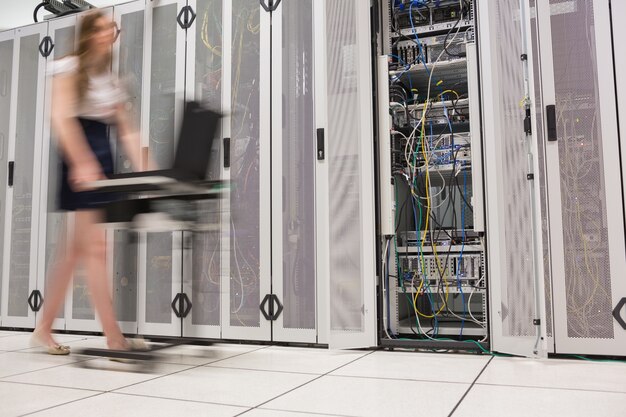Photo woman pushing computer through data center