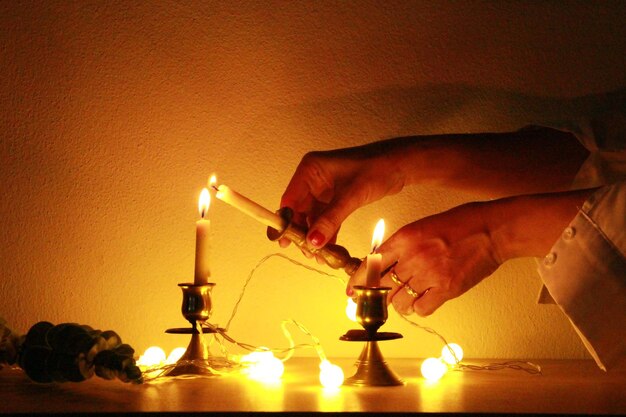 Woman put up the candle fire in the dark room