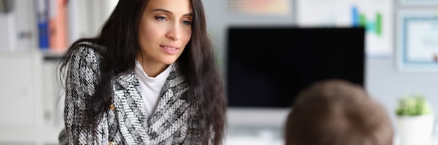 Woman puts pressure on man sitting in front her