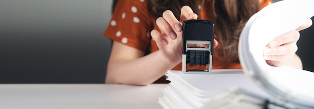 Woman puts a stamp on documents