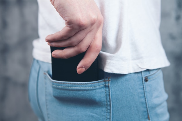 Woman puts wallet in her pocket