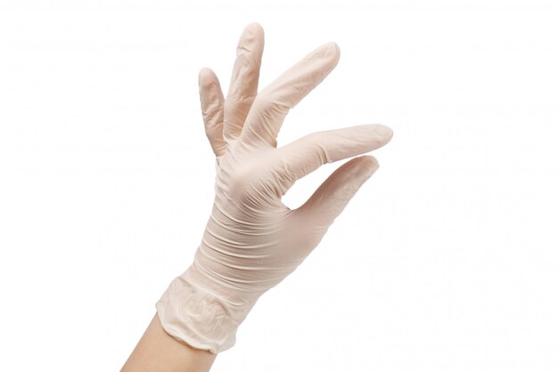 Woman puts on white rubber gloves.