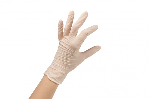 Woman puts on white rubber gloves.