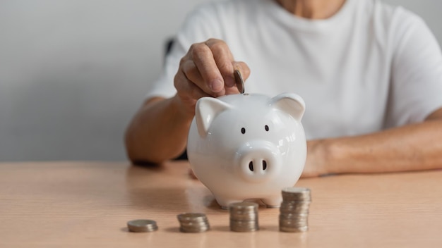 woman putting coin into piggy bank and saving money plan retirement fund earning money investment