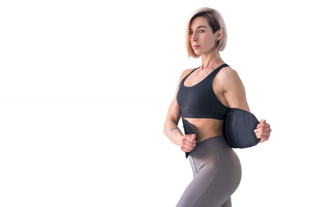 Woman putting on fitness back belt slimming isolated