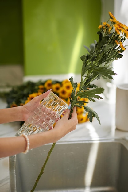 Woman Putting Flowers in Vase