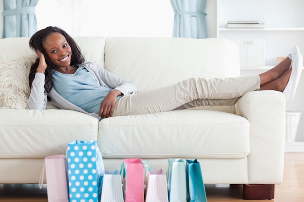 Woman putting her feet up after shopping