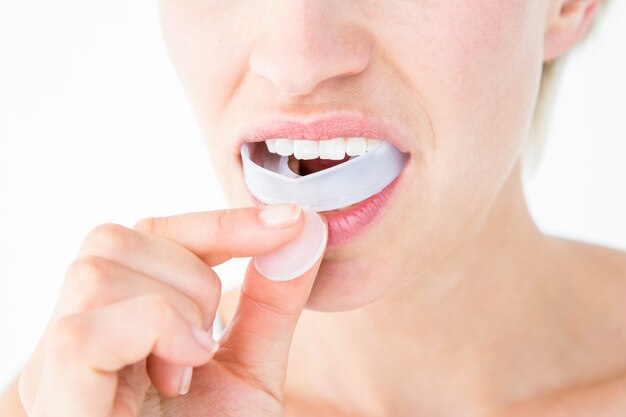 Woman putting her gum shield 