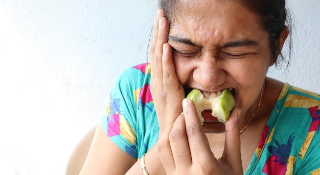 Woman putting her hand on her cheek due to toothache