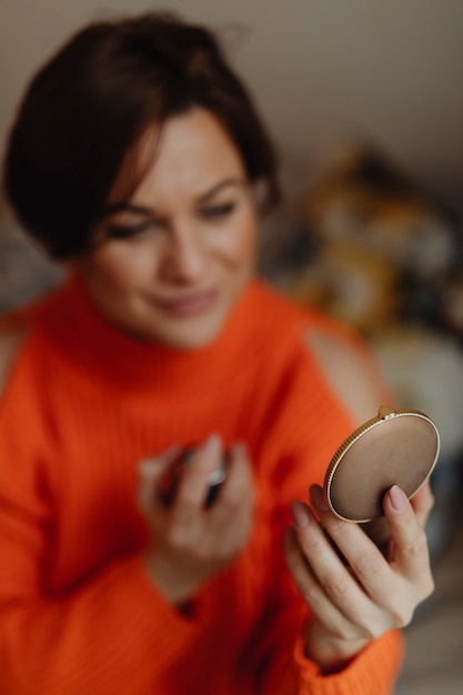 Woman putting on perfume